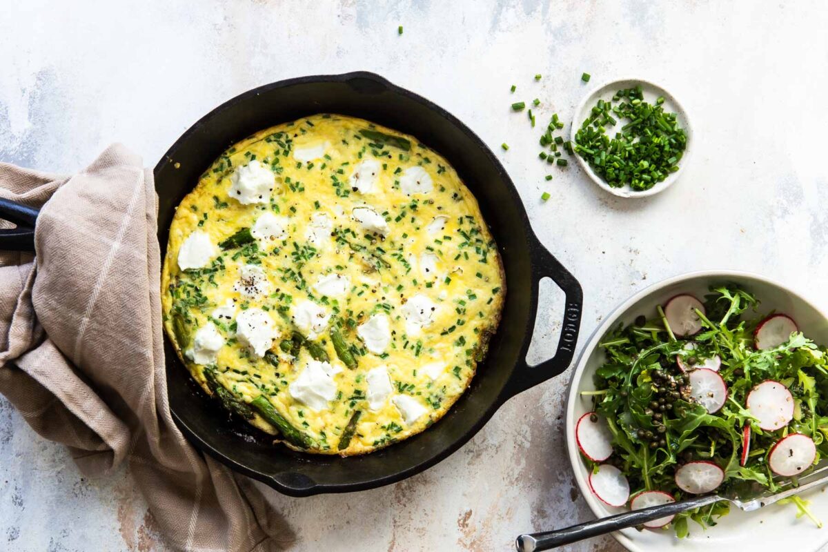 Asparagus fritatta after being cooked in a cast iron skillet.