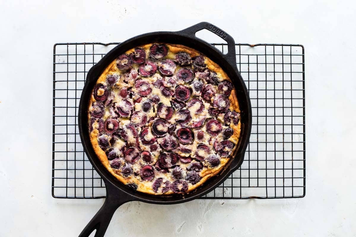 A cast iron skillet with Cherry Clafoutis.