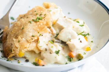 Chicken pot pie in a white dish.