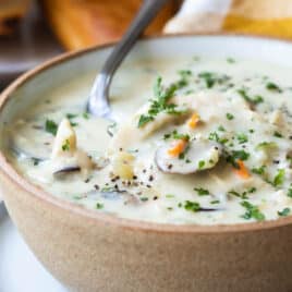 Chicken wild rice soup in a brown bowl.
