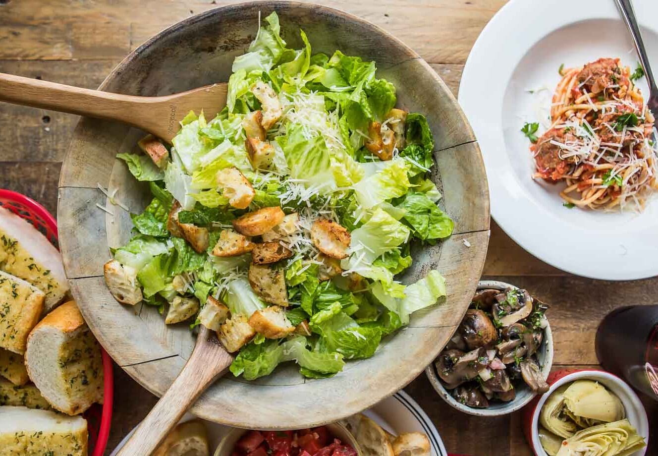 A spread of Italian food on a wooden table.