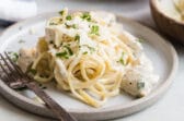 Two plates of chicken alfredo.