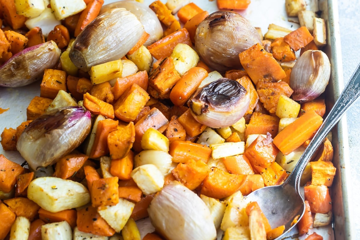 Roasted root vegetables on a baking sheet.