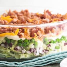 Seven layer salad in a glass dish.