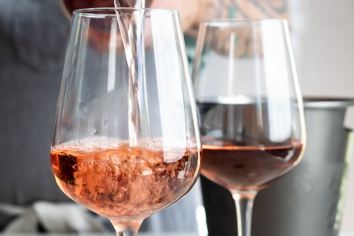 Rosé wine being poured into a glass.