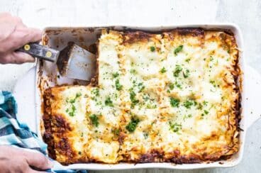 A white baking dish of lasagna.